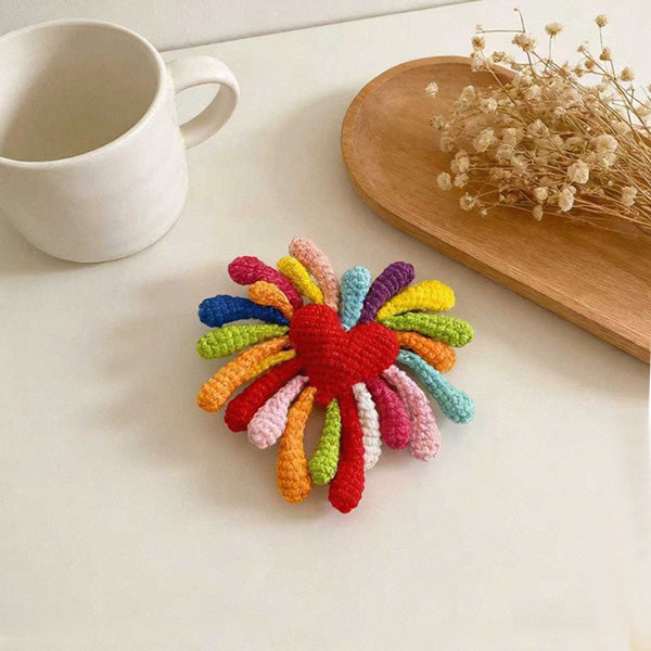 Crochet firework flower keychain on white background