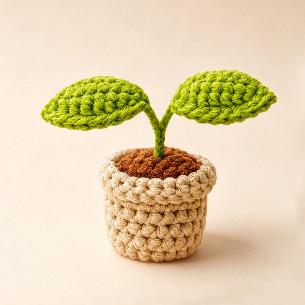 Crochet sprout plant pot on beige background