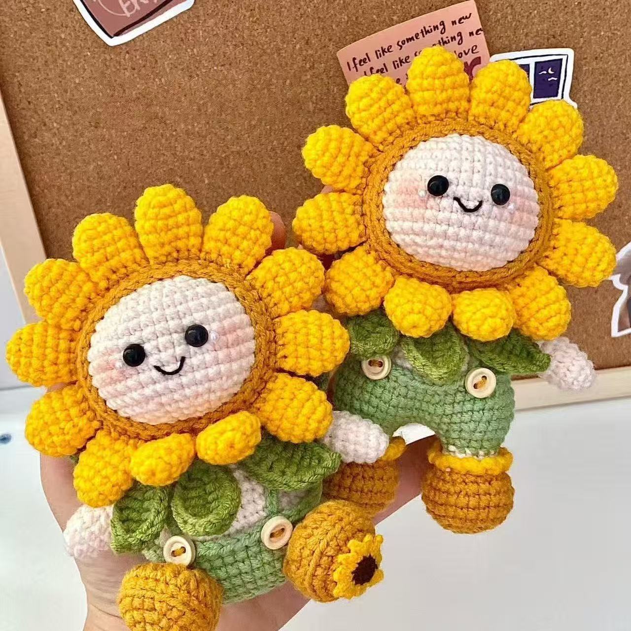 Completed crochet sunflower doll from DIY kit — smiling face with petal crown and green overalls