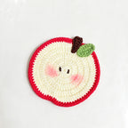 Crochet apple coaster styled with mug on desk | Knoblom