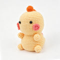 Crochet chick doll with orange beak, front view | Knoblom