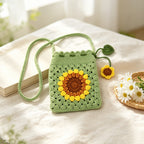 Crochet granny square purse with leaf-and-flower charm, front view | Knoblom