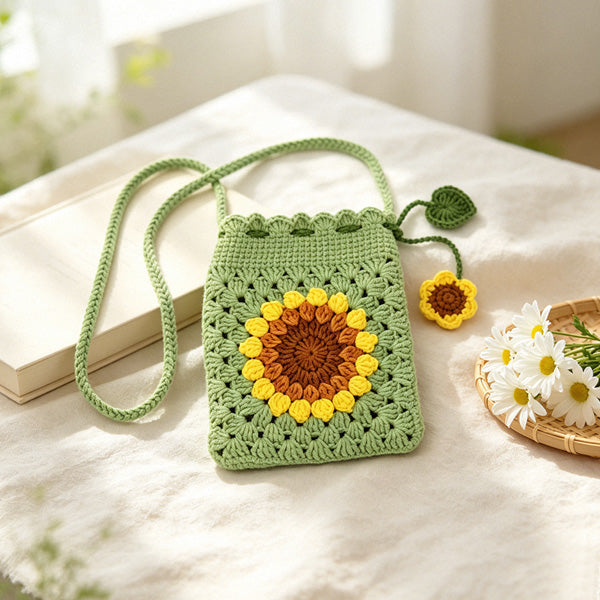 Crochet granny square purse with leaf-and-flower charm, front view | Knoblom