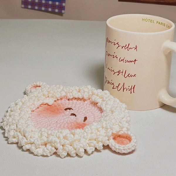 Crochet lamb coaster with tiny round ears, styled with cup | Knoblom