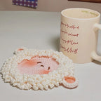 Crochet lamb coaster with tiny round ears, styled with cup | Knoblom