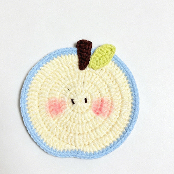 Handcrafted apple coaster close-up, soft cotton yarn texture | Knoblom