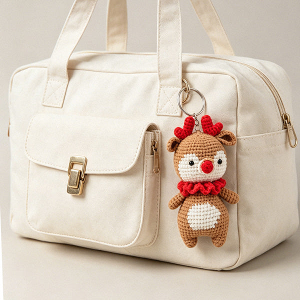 Handcrafted crochet reindeer with fluffy red ruffle collar, side view | Knoblom