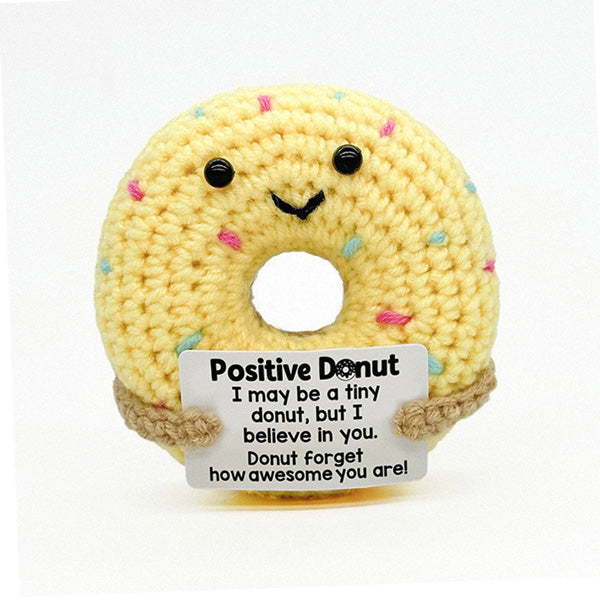 Handcrafted smiley donut crochet toy, close-up face detail | Knoblom