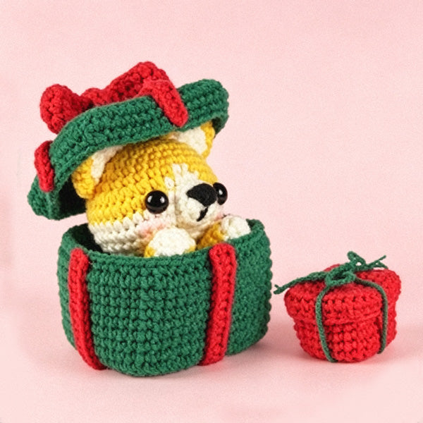 Handmade crochet Corgi gift box plush toy on pink background - close up