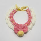 Handmade crochet blue and pink lace ruffle pet collar with bow and yellow pom-pom, flat lay | Knoblom