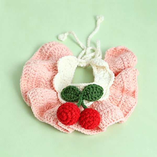 Handmade crochet cherry pet bib collar in pink on white background