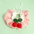 Handmade crochet cherry pet bib collar in pink on white background