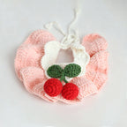 Handmade crochet cherry pet bib collar in yellow on pink background