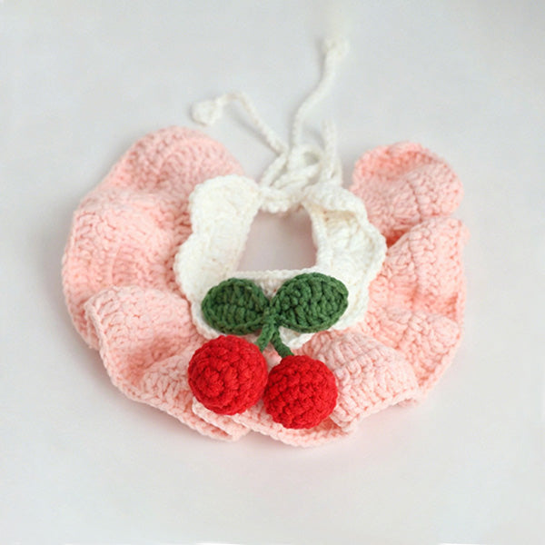 Handmade crochet cherry pet bib collar in yellow on pink background