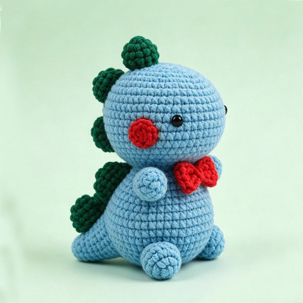 Handmade crochet dinosaur amigurumi in sky blue with green spikes | Knoblom
