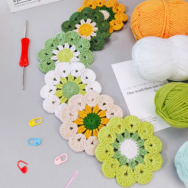 Handmade crochet green and yellow mandala coaster on green background