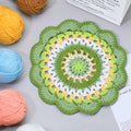 Handmade crochet green mandala coaster in forest green, lime and white