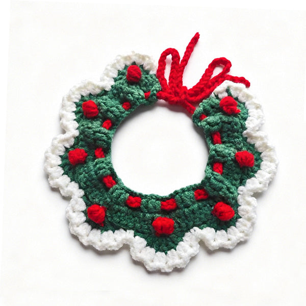 Handmade crochet pet collar in Christmas green with red pom-poms, scalloped edge detail \| Knoblom