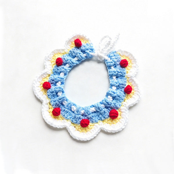 Handmade crochet pet collar in blue and white with yellow pom-poms, adjustable tie \| Knoblom
