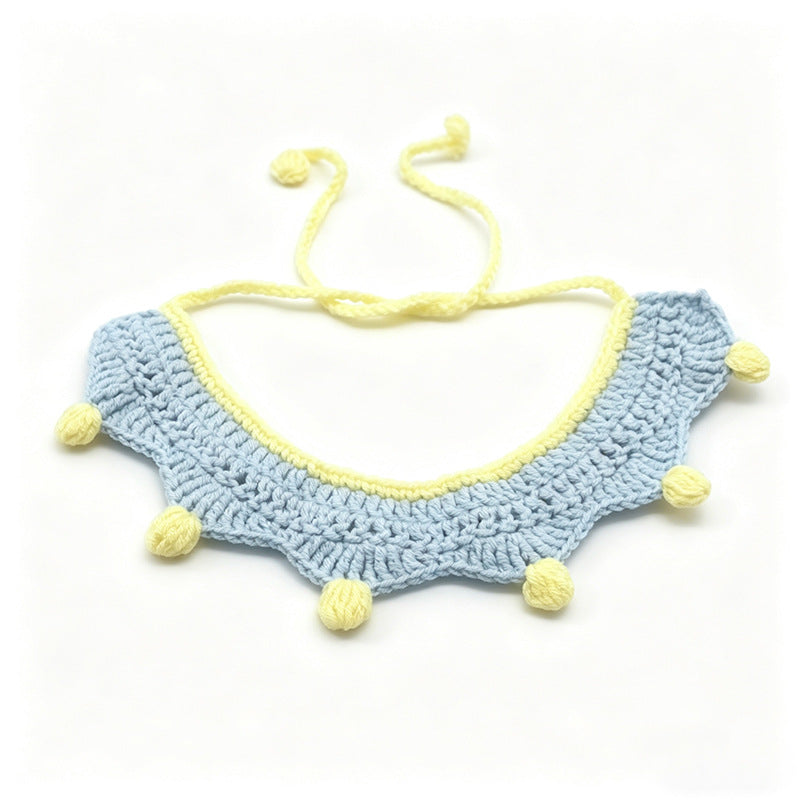 Handmade crochet pet collar in blue and yellow with red pom-poms, adjustable tie closure \| Knoblom