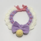 Handmade crochet red and white lace ruffle pet collar with velvet bow, pearl button and jingle bells, flat lay | Knoblom