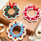 Three handmade crochet Christmas pet collars in green, red, and blue displayed together \| Knoblom