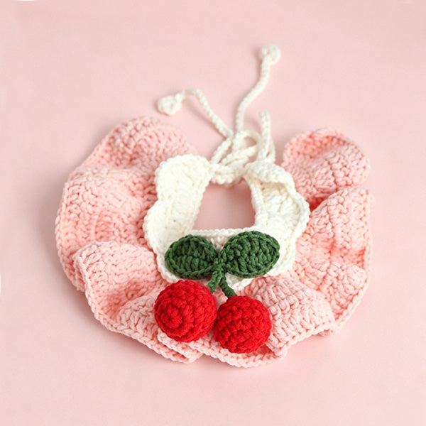 White cat wearing handmade crochet cherry bib collar in pink